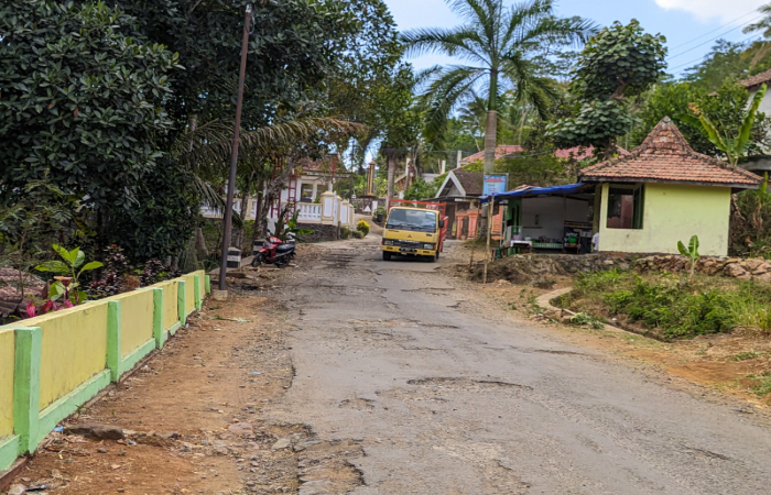 RUSAK BERAT: Salah satu kendaraan roda empat melintasi jalur utama Kecamatan Pule dengan kondisi jalan banyak yang berlubang.