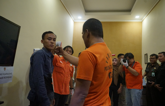 HARUS ADIL:  EP alias Glowo, tersangka pembunuhan  pasutri di Ngantru, Tulungagung, saat menjalani rekonstruksi.