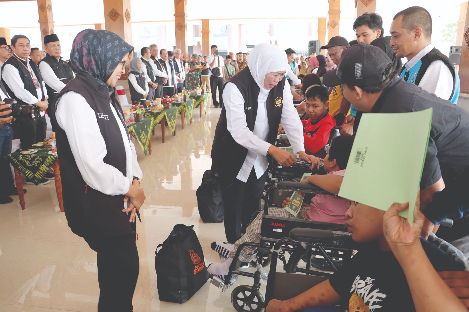 RAMAH: Gubernur Khofifah didampingi Bupati Rini menyerahkan bantuan kepada penyandang disabilitas.