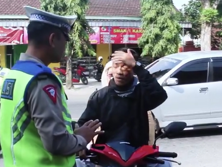 WADUH: Pengendara motor diberhentikan polisi lantaran tak memakai helm