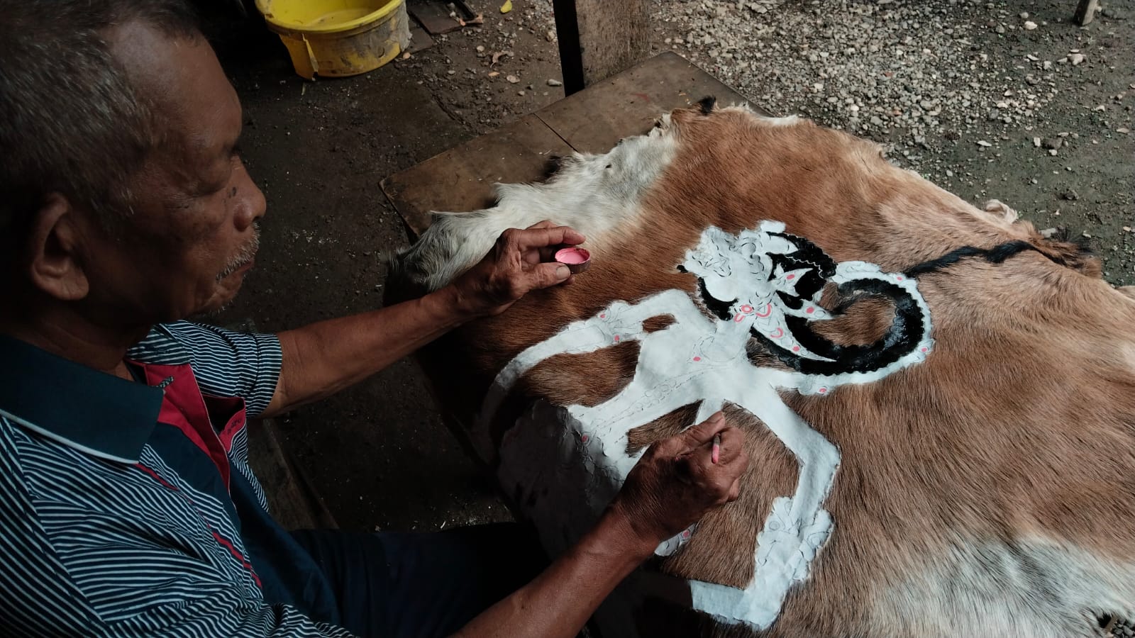 Sumiran sedang menyelesaikan lukisan tokoh wayang Anoman. (WANDA AK/RADAR TRENGGALEK)
