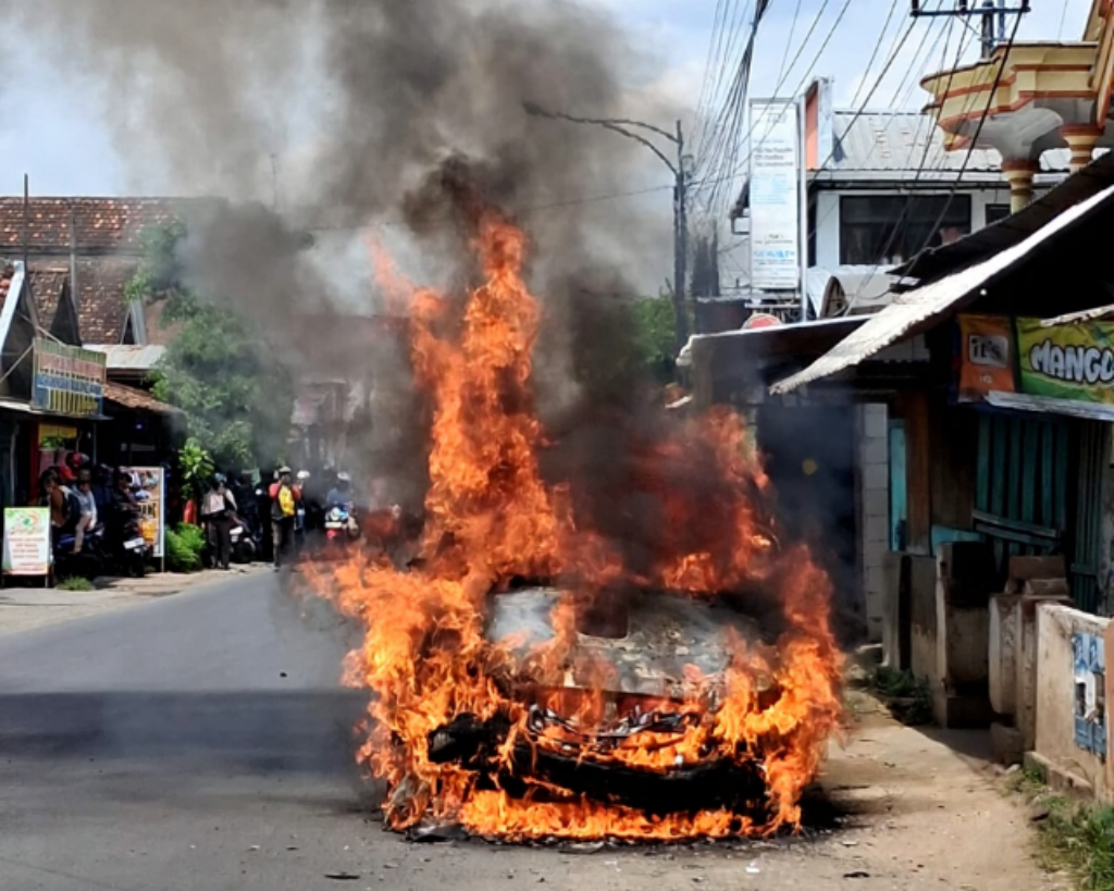 Kondisi mobil milik Suwanto yang terbakar usai korsleting listrik di Jalan Raya Bendilwungu, Kecamatan Sumbergempol pada Sabtu (3/1) siang. (DPKP TULUNGAGUNG)