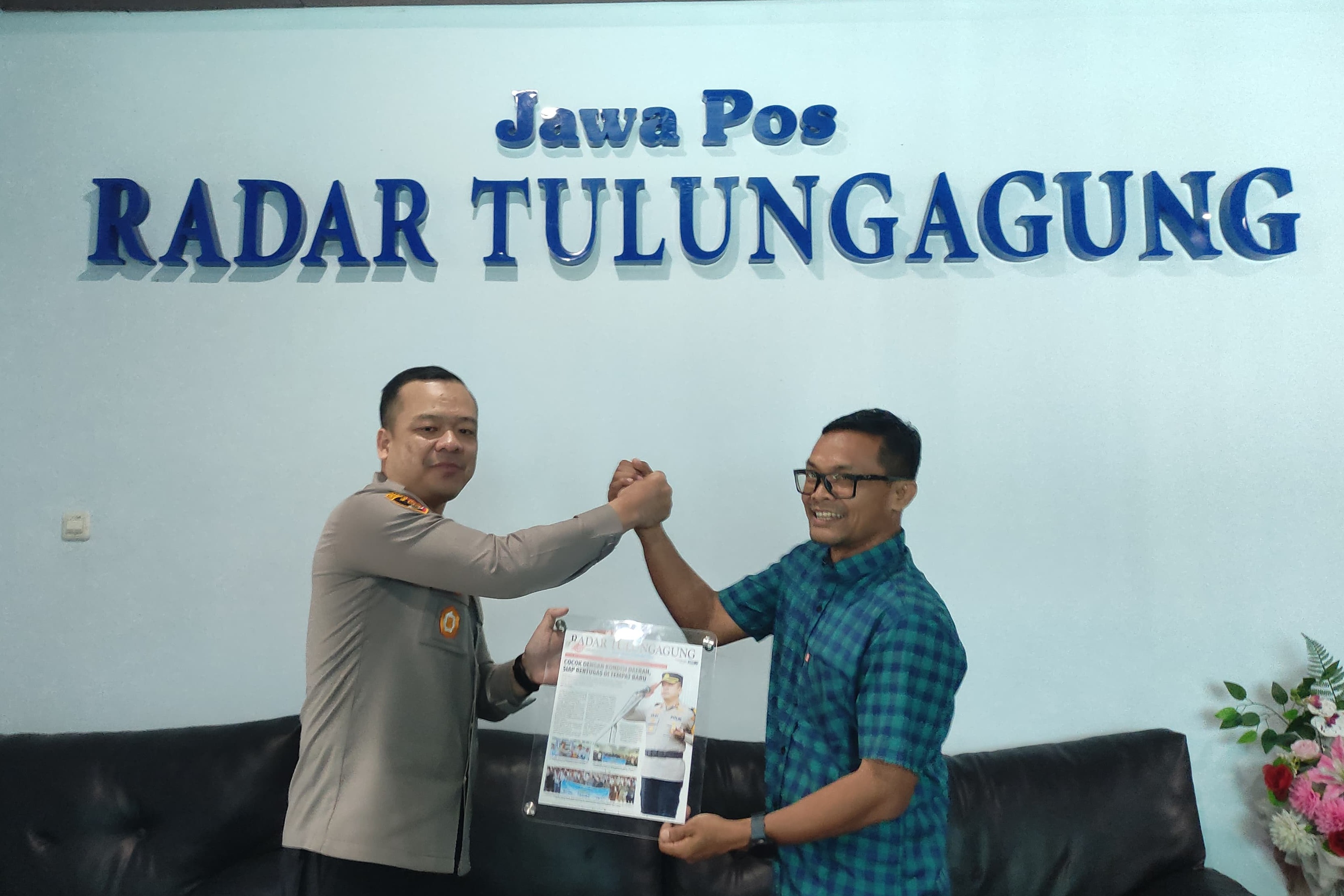 AKBP Muhammad Taat Resdi menerima cenderamata dari GM Radar Tulungagung Andrian Sunaryo. (SANDY YUWANA/RADAR TULUNGAGUNG)