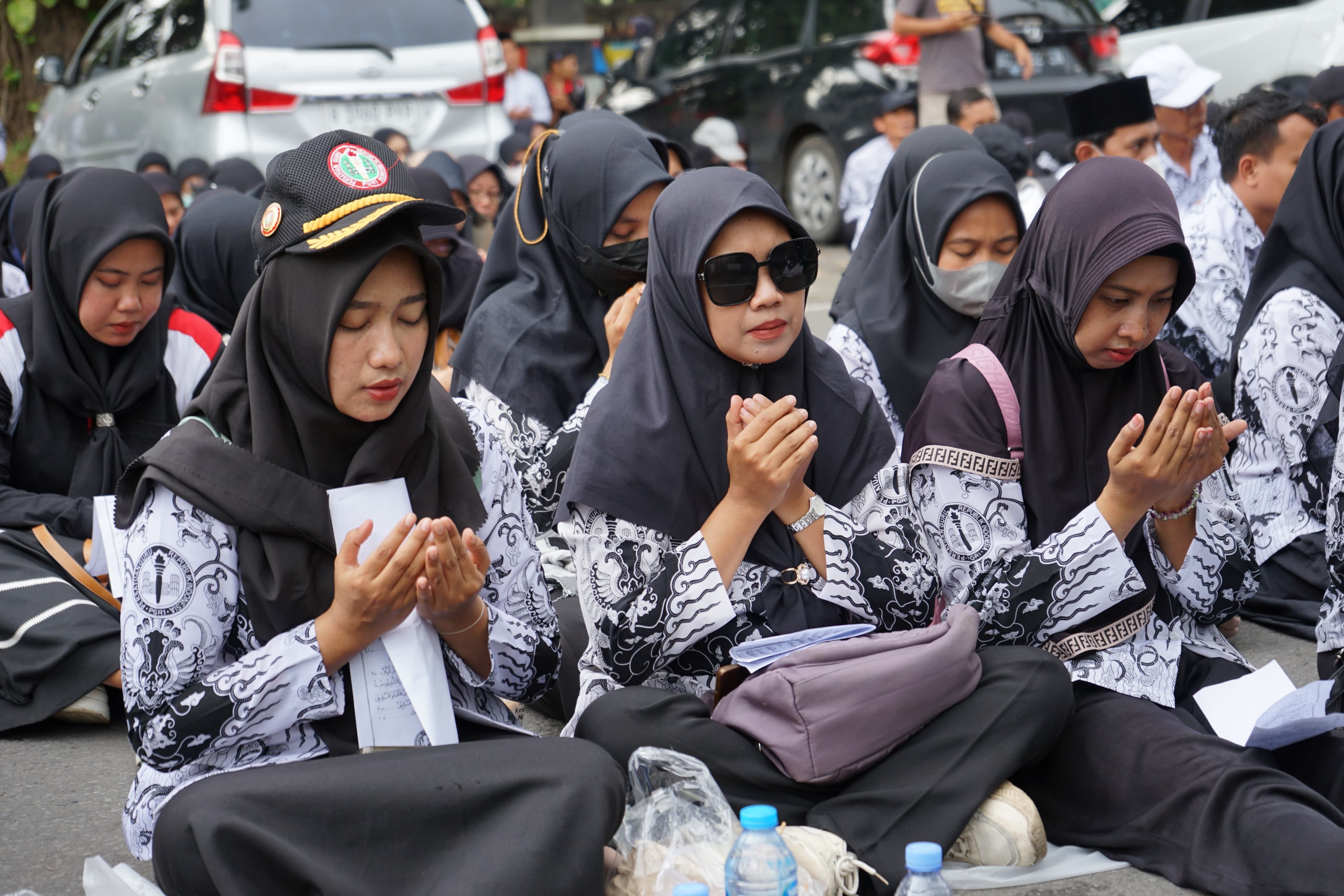 Ratusan guru dan tendik P3K paruh waktu duduk bersila di depan gedung DPRD dewan untuk menuntut kelayakan gaji.(SANDY YUWANA/RADAR TULUNGAGUNG)