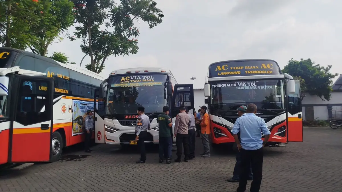 Petugas Terminal Gayatri Tulungagung melakukan pemeriksaan rutin armada bus di area terminal, Jumat (27/3/2026).(RAHIIQ AL BACHRI/RADAR TULUNGAGUNG)