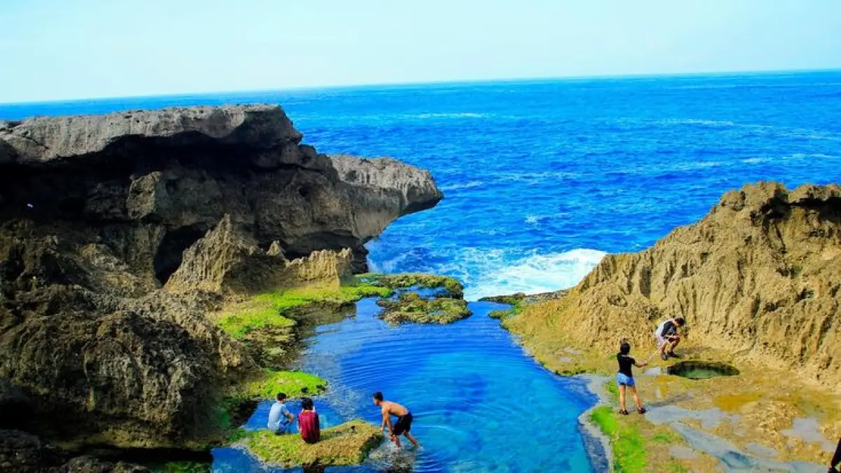Pantai Kedung Tumpang Tulungagung viral dengan laguna alami di karang, ombak besar Samudra Hindia, dan pemandangan eksotis anti-mainstream (Pinterest).