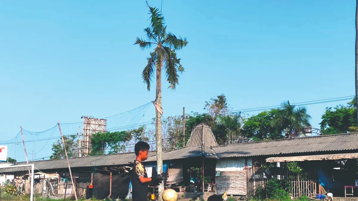 Dua anak kecil berlatih sepak bola di area lapangan Pasar Pahing yang awalnya dibidik untuk calon lokasi KKMP milik Kelurahan Karangwaru.(SANDY YUWANA/RADAR TULUNGAGUNG)