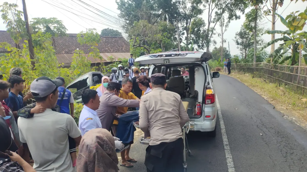 Petugas bersama warga mengevakuasi korban kecelakaan lalu lintas di Jalan Raya Dusun Pabyongan, Desa Mulyosari, Kecamatan Pagerwojo, Senin (3/8).(POLSEK PAGERWOJO)