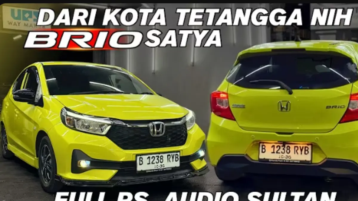 Modifikasi Honda Brio Satya Electric Lime jadi look RS dengan fog lamp, body kit, spoiler, head unit Nakamichi, peredam, dan upgrade audio.
