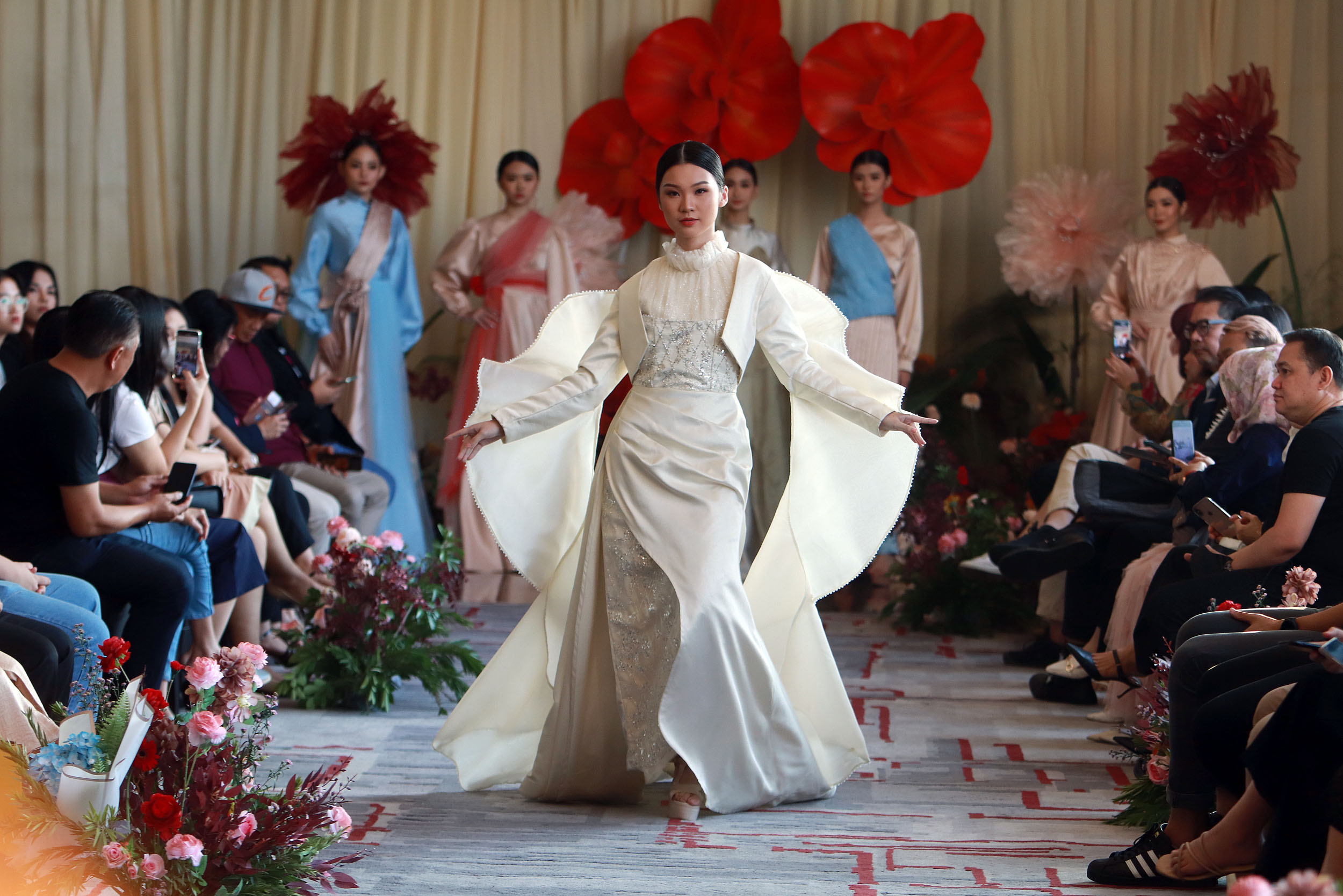 EVENING GOWN: Model berpose dengan busana karya desainer muda mahasiswa Petra Christian University yang mengangkat tema Wandering Souls in Paradise. (ANDY SATRIA/RADAR SURABAYA)