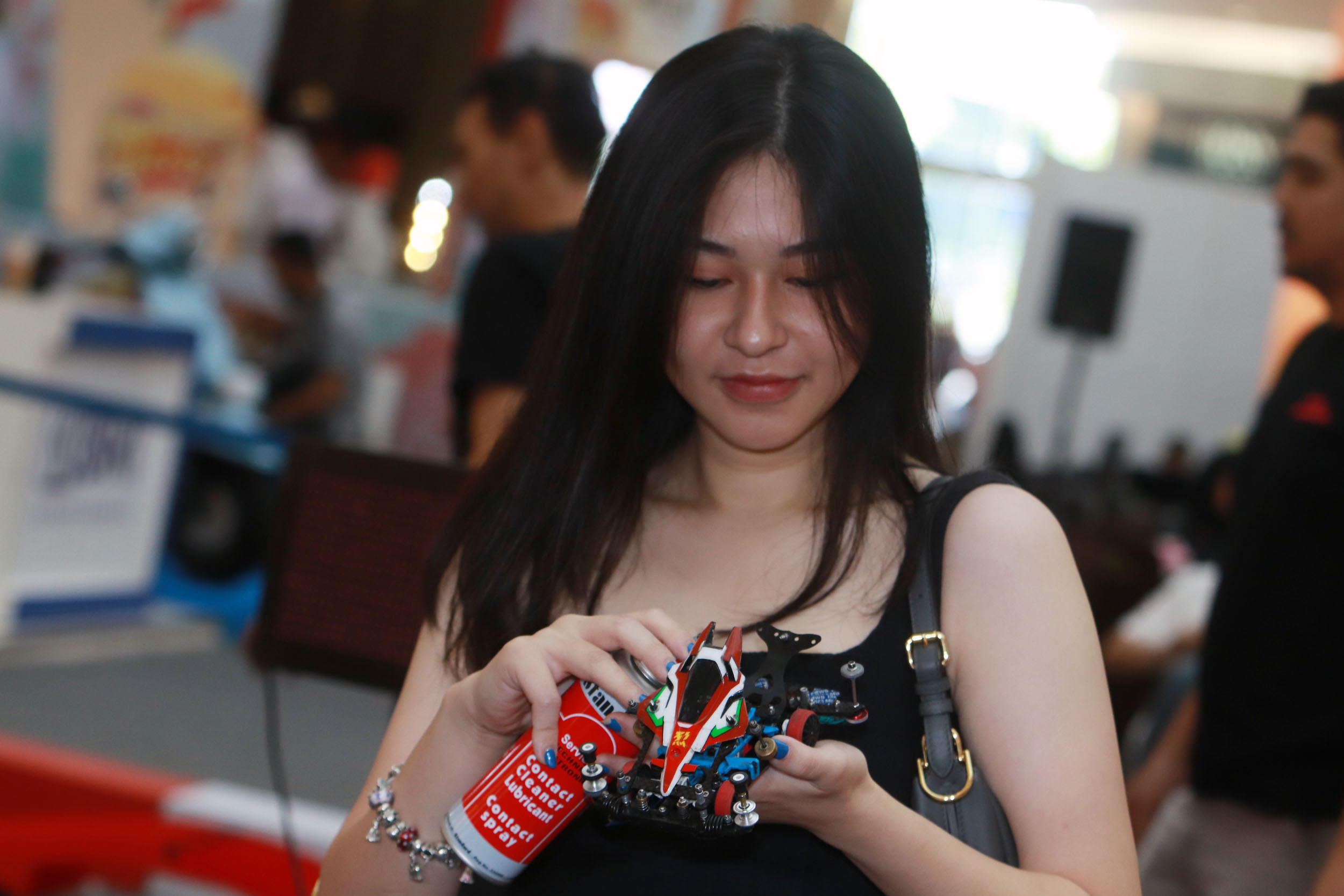 ADU MEKANIK: Salah satu peserta lomba Tamiya, mempersiapkan mobil mereka sebelum diturunkan dalam lomba yang digelar di Atrium Ciputra World Surabaya, Minggu (6/8). (ANDY SATRIA/RADAR SURABAYA)