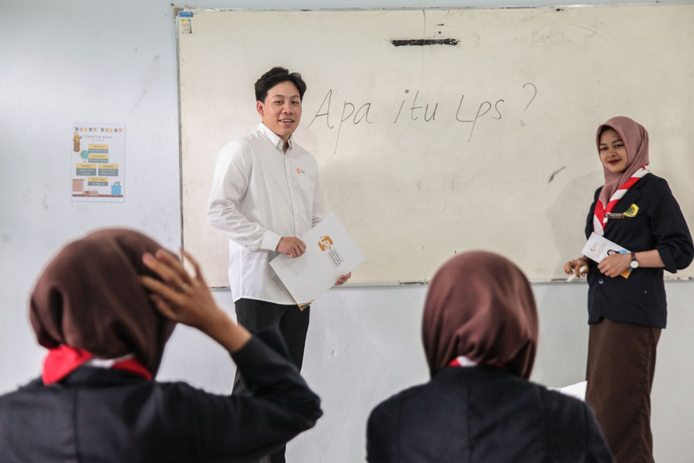 Staf Litigasi LPS Leo Chandra (kiri) memberikan penjelasan terkait keamanan menyimpan uang di bank kepada siswa di SMK Zainul Hasan, Jember, Jawa Timur. (SURYANTO/RADAR SURABAYA)