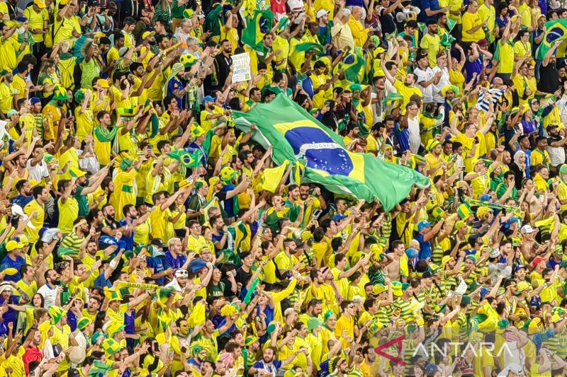 Para suporter tim nasional Brazil melambaikan bendera raksasa negaranya saat merayakan gol Casemiro ke gawang Swiss dalam lanjutan Grup G Piala Dunia 2022 di Stadion 974, Doha, Qatar, Senin (28/11).