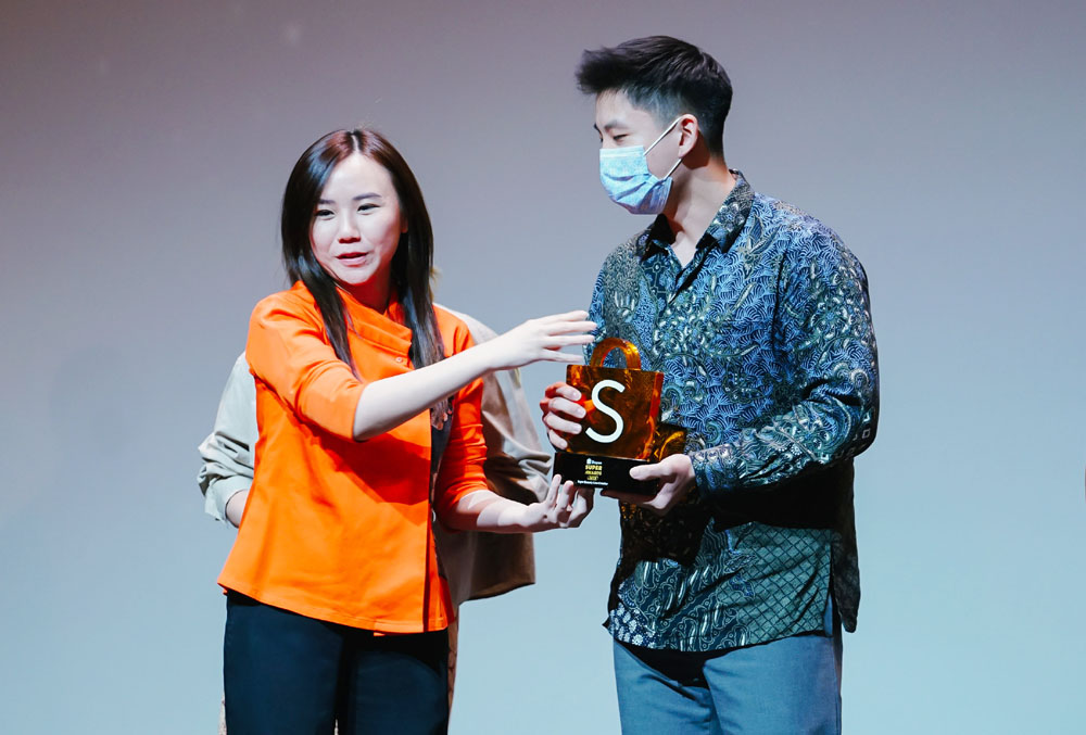 Christin Djuarto, Direktur Eksekutif Shopee Indonesia memberikan penghargaan kategori Super Growing UMKM kepada Given Susanto, pemilik Heura Perfume di Shopee.