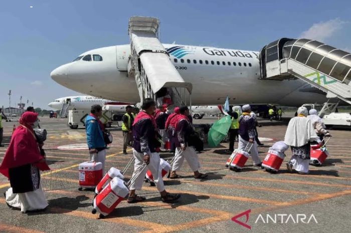 SIAP BERTOLAK: Sejumlah calon jemaah haji (CJH) Indonesia 2024 berjalan menuju ke pesawat Garuda Indonesia yang akan membawa mereka ke Tanah Suci. (ANTARA)