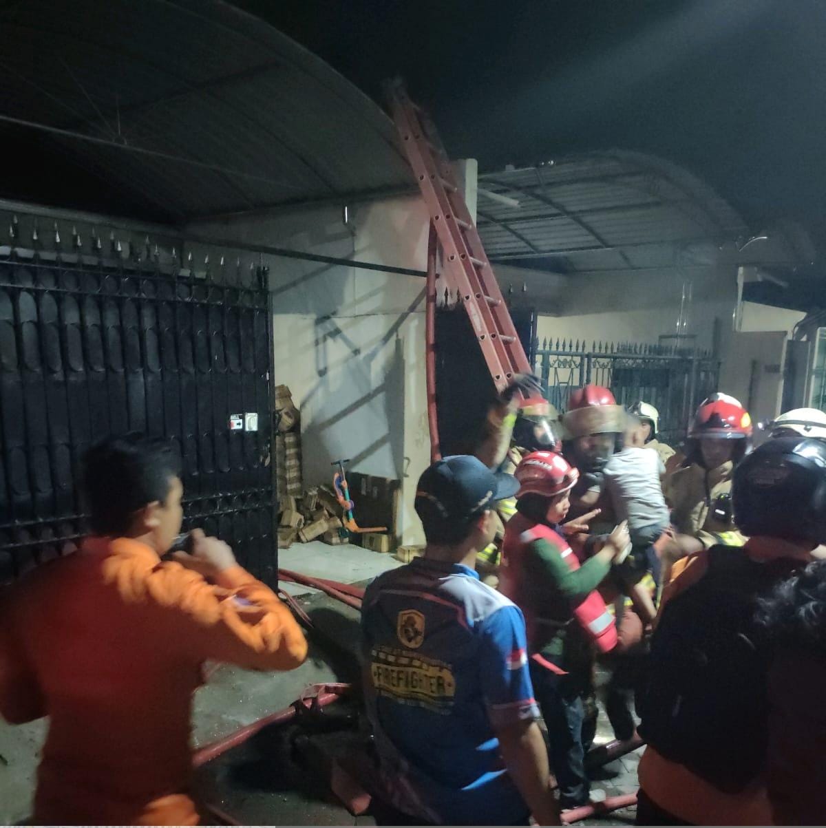 Kebakaran rumah di Jalan Kedung Cowek, Jumat (31/5) dini hari. Anak dan Istri sempat terjebak di lantai II. Petugas DPKP berhasil menyelamatkan keduanya (IST).