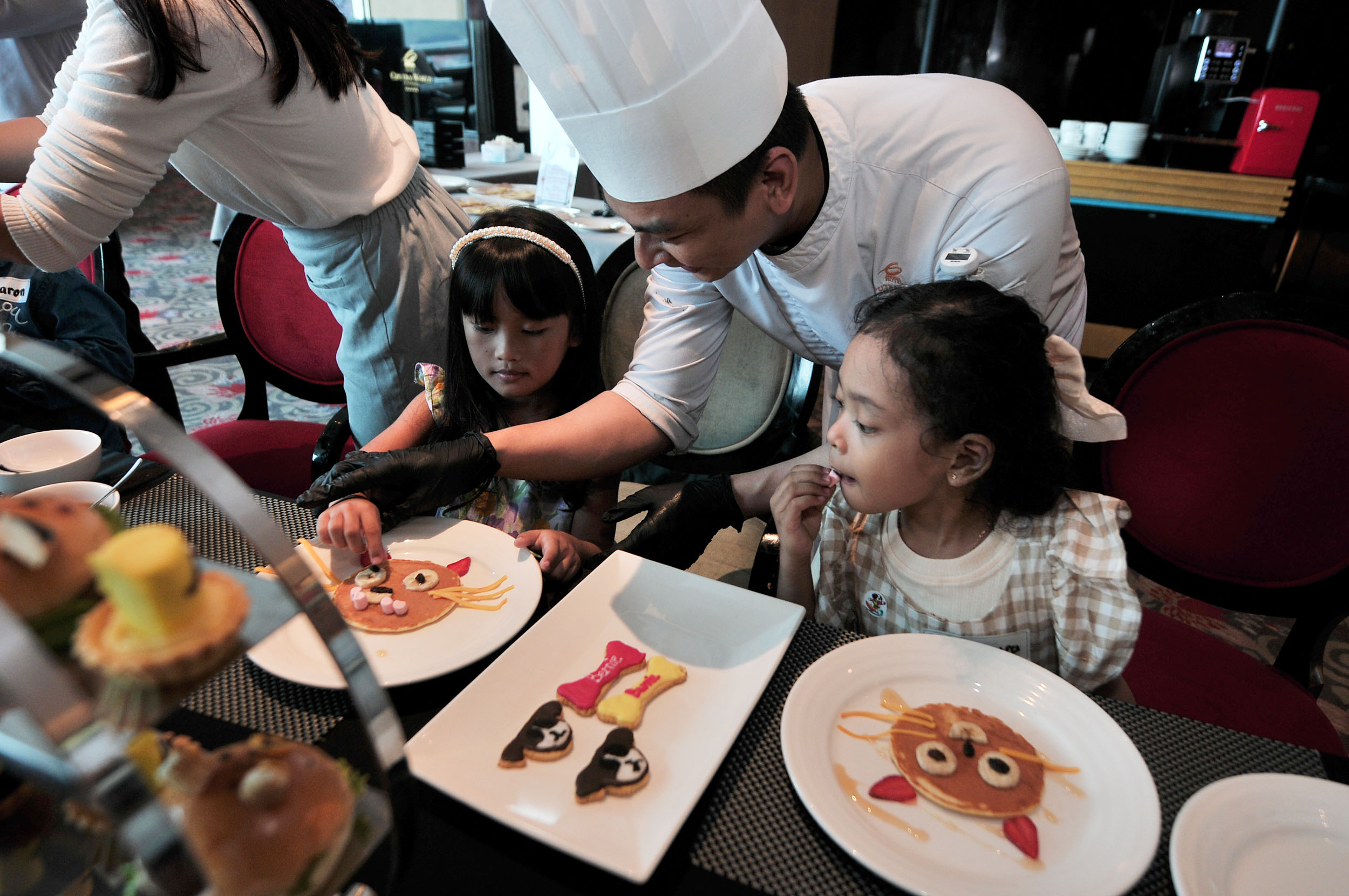 BERKREASI: Chef Ferdianzah mengajarkan anak-anak peserta kids cooking class menghias pancake untuk mengisi libur sekolah di Hotel Ciputra Surabaya, Senin (24/6).