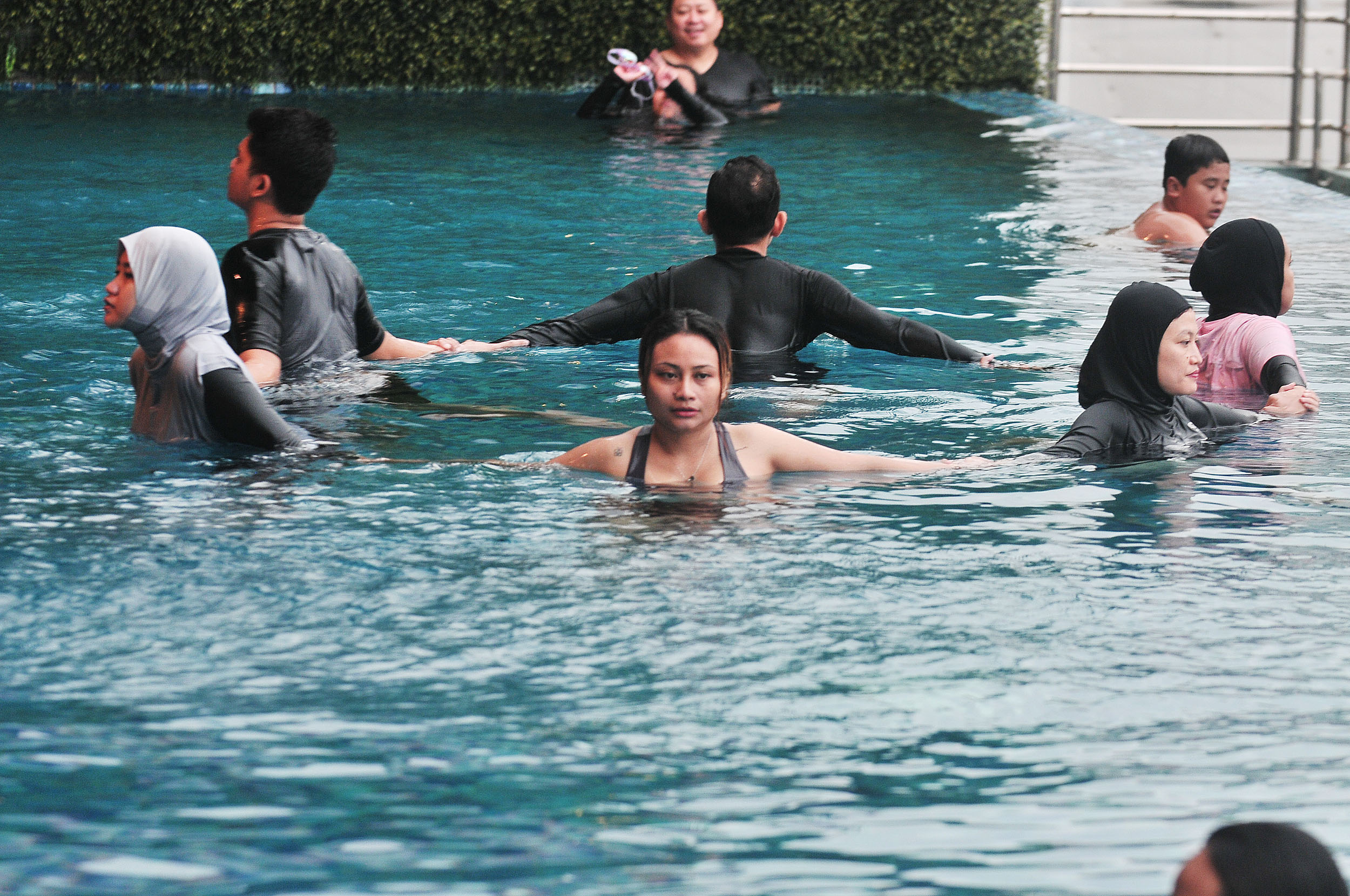 TERAPI ALTERNATIF: Sejumlah peserta aqua yoga melakukan gerakan-gerakan yang diinstruksikan pelatih di kolam renang hotel Doubletree Surabaya, Selasa (28/1).