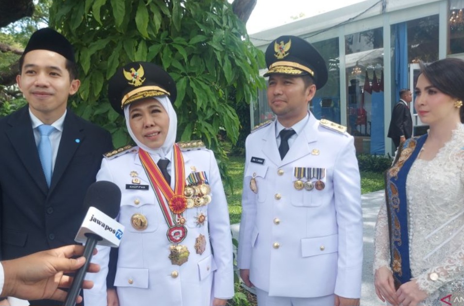 Gubernur Jawa Timur Khofifah Indar Parawansa didampingi Emil Dardak dan keluarga saat menyampaikan keterangan usai pelantikan serentak kepala daerah di kompleks Istana Kepresidenan, Jakarta.
