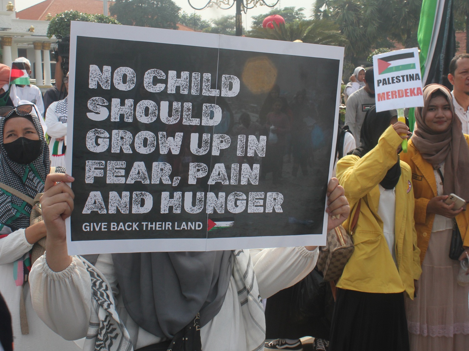 Peserta aksi Bela Palestina membawa beragam poster dukungan untuk kebebasan Palestina di Jalan Gubernur Suryo Surabaya, Sabtu (19/4).