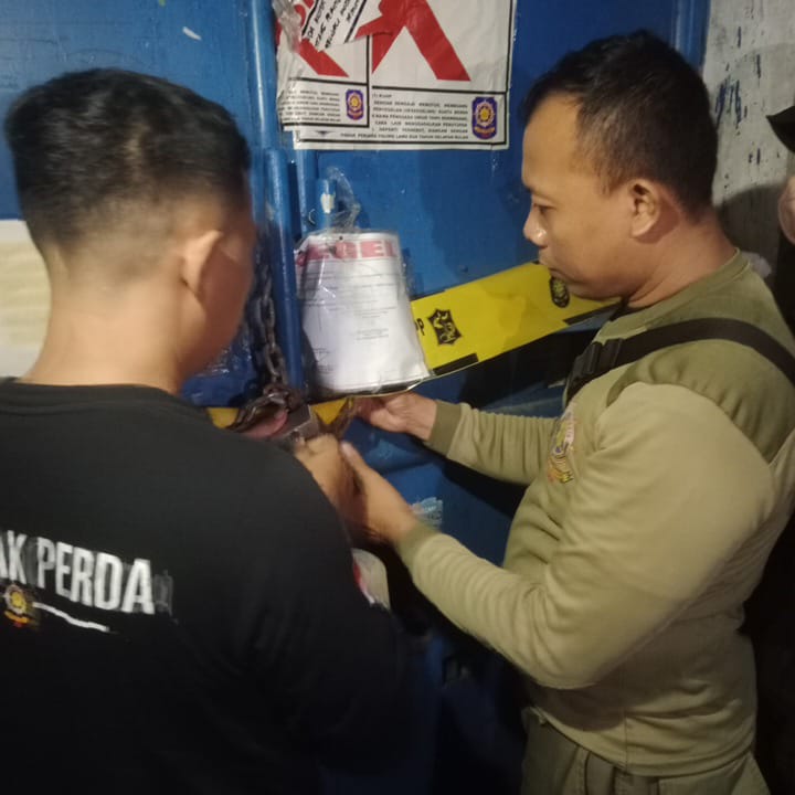 MELANGGAR ATURAN: Satpol PP menggembok gudang UD Sentoso Seal karena masih beroperasi padahal sudah disegel beberapa waktu lalu.