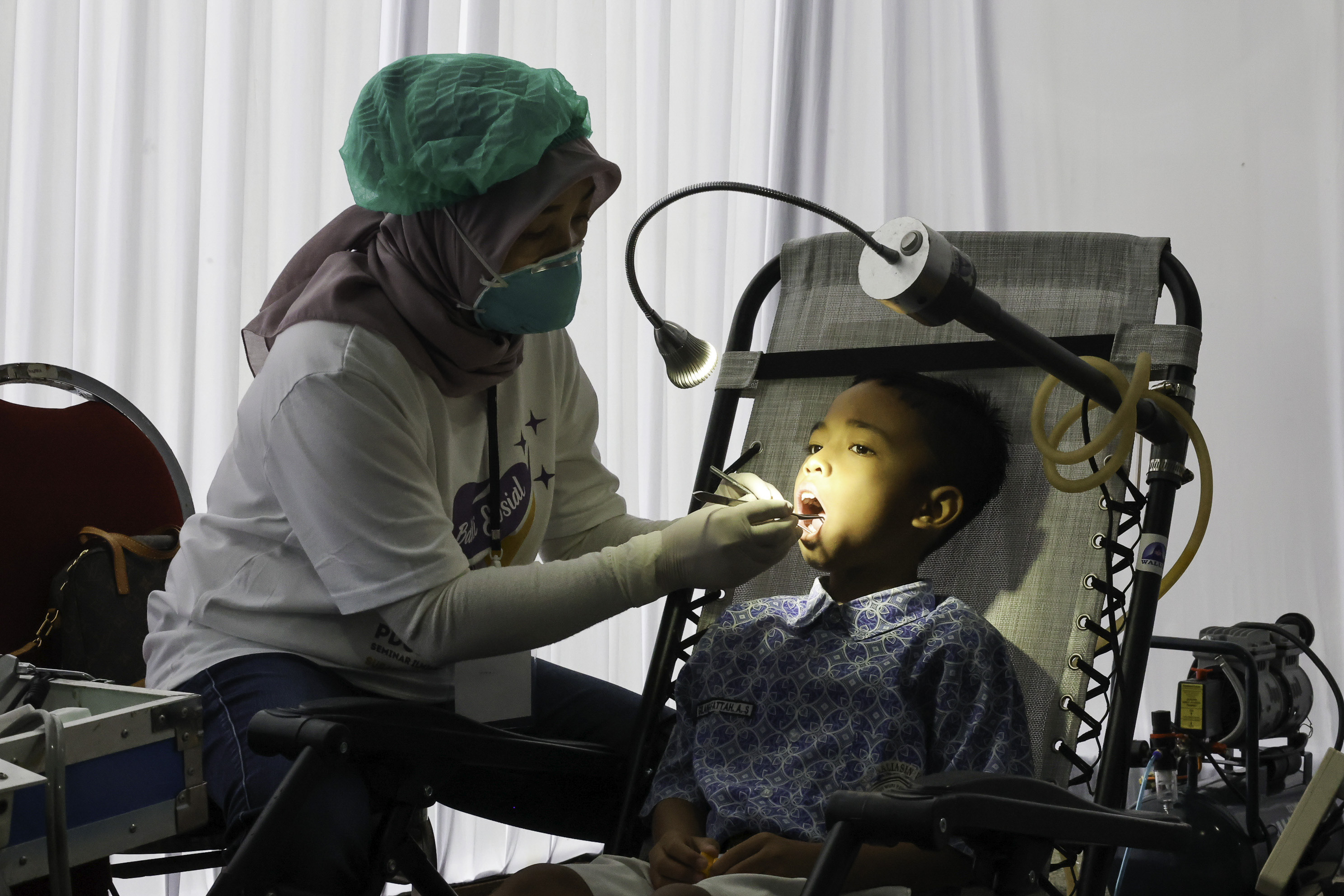 Kegiatan pemeriksaan gigi anak sekolah dalam kegiatan Baksos Terintegrasi dan Donor Darah di Halaman Balai Kota Surabaya, Sabtu (17/5).&nbsp;