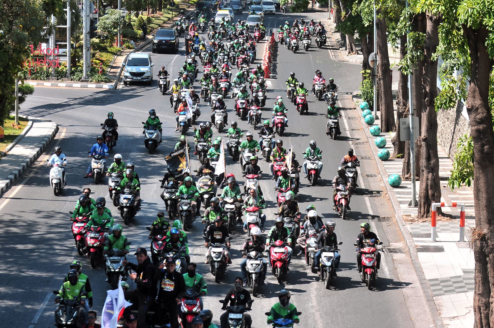 BERGERAK : Pengendara ojol melaksanakan demo di Surabaya. Massa akan berkeliling dan berkumpul di Kantor Gubernur Jawa Timur, Jalan Pahlawan, Surabaya. (ANDY SATRIA/RADAR SURABAYA)