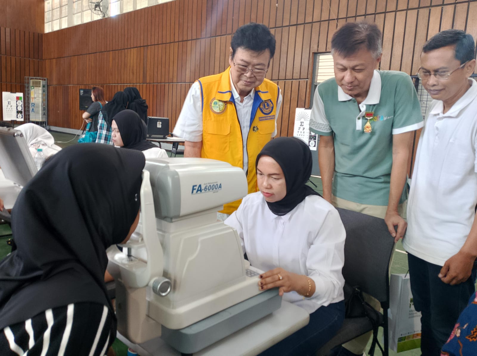KEGIATAN SOSIAL: Direktur Eksekutif PPPK Petra Hengkie Porawouw (tengah) berkolaborasi antara Lions Club International dan Dinas Kesehatan Kota Surabaya melihat proses pemeriksaan kesehatan mata.