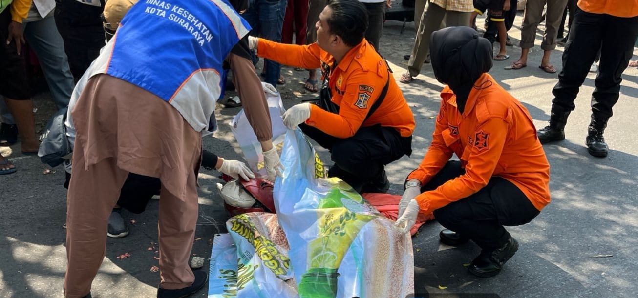 NAHAS : Petugas saat mengevakuasi jasad korban pengendara motor di lokasi kecelakaan Jalan Simo Pomahan, Surabaya Senin (16/6). (IST/RADAR SURABAYA)