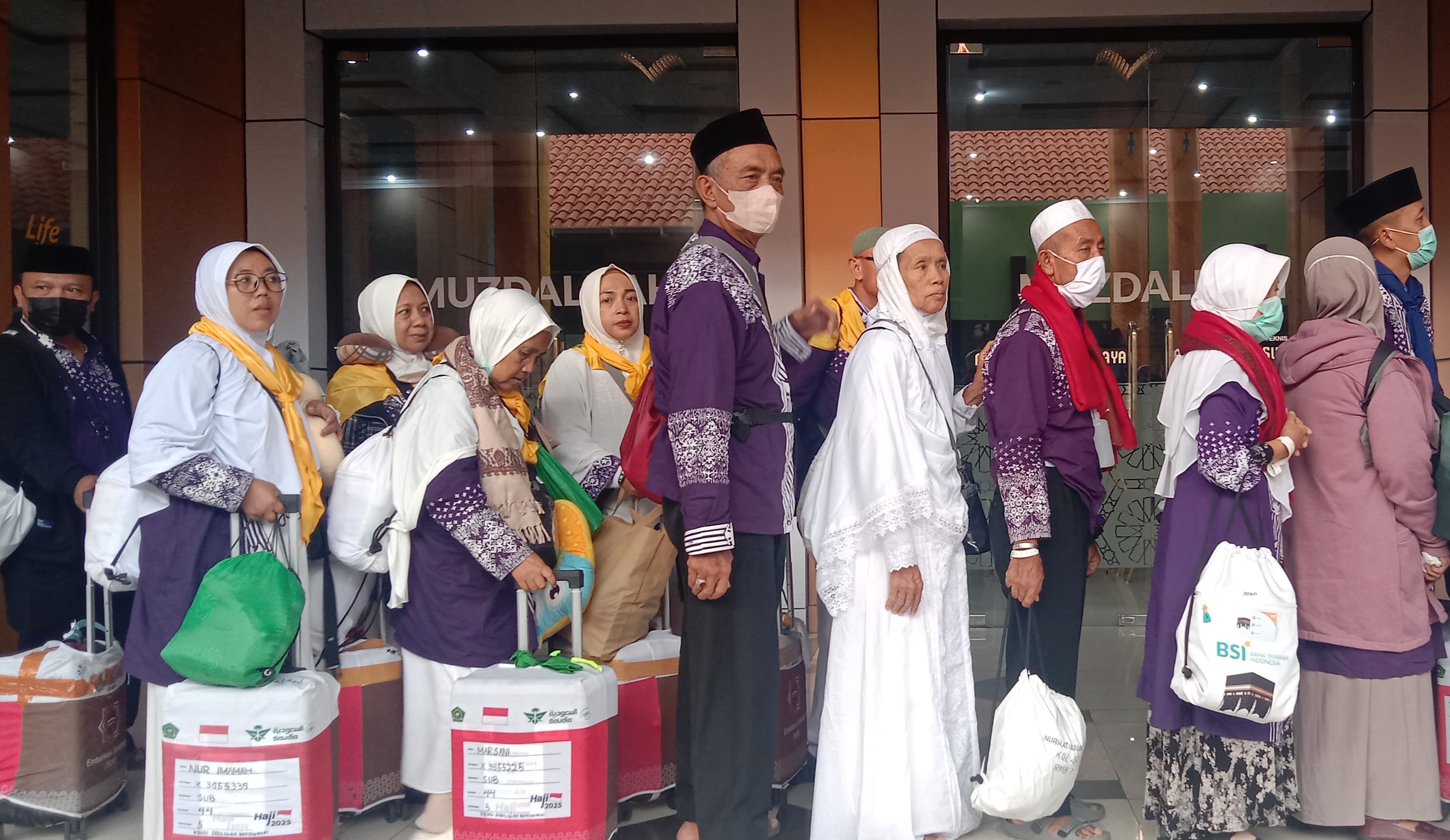 TIBA SELAMAT: Jemaah haji kloter 44 asal Banyuwangi dan Pamekasan yang sebelumnya mengalami penundaan kepulangan karena konflik timur tengah tiba di Asrama Haji Debarkasi Surabaya, Rabu (25/6) sore.
