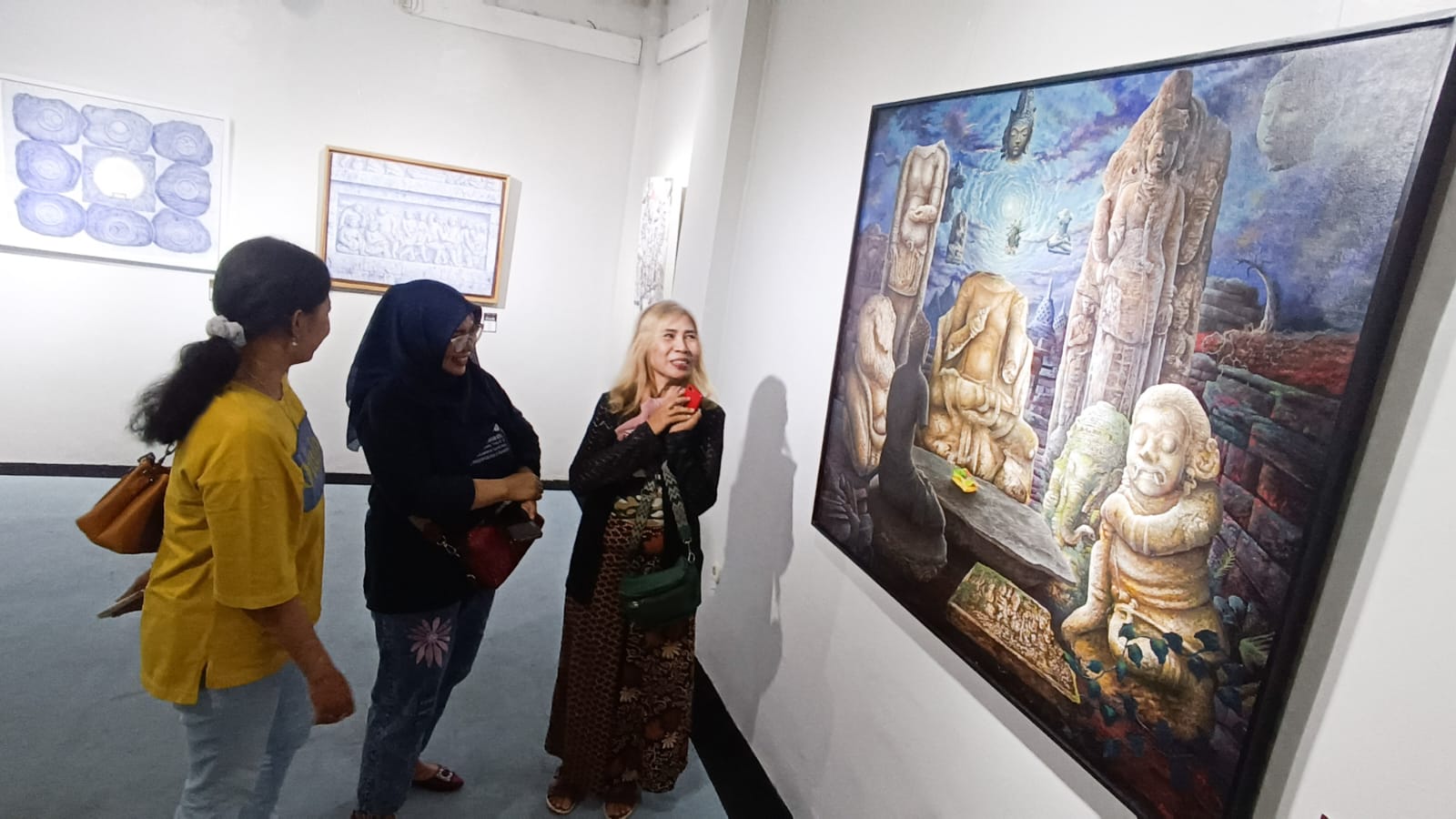 CANDI: Sejumlah pengunjung mengamati karya lukis yang dipamerkan dengan tema Candi karya perupa Jawa Timur, yang dipamerkan di Galeri Prabangkara, Komplek Taman Budaya Jawa Timur, Minggu (13/7).