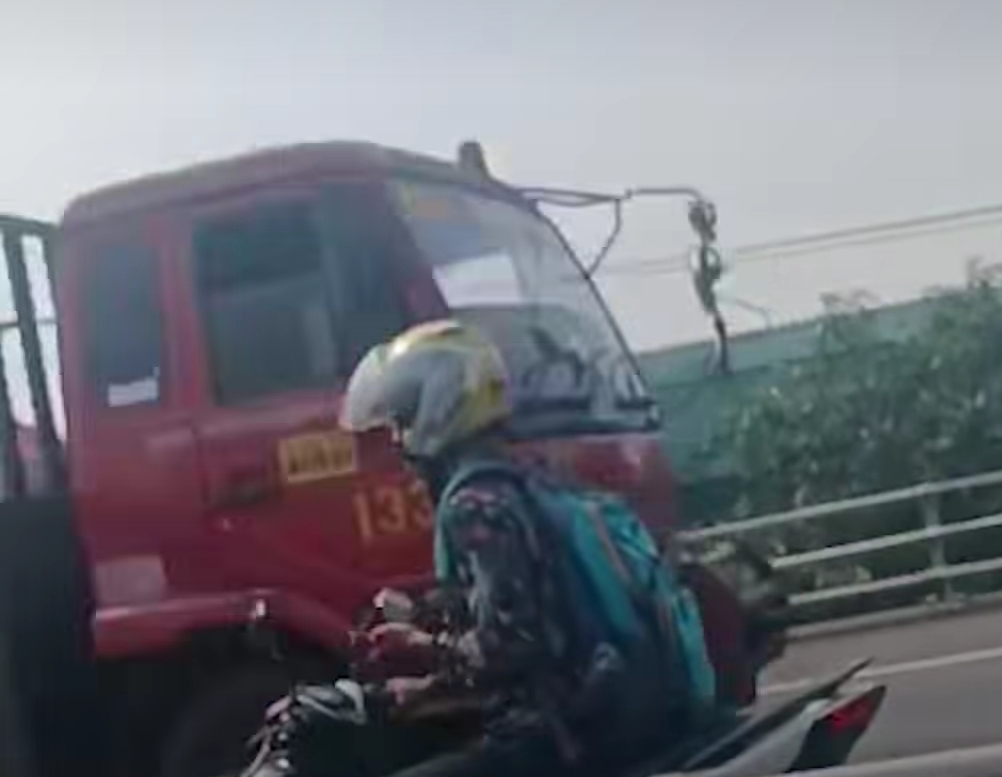 KEBINGUNGAN : Pengendara sepeda motor viral usai terekam pengemudi mobil saat masuk Tol Satelit arah Perak dan melawan arus. (IST/RADAR SURABAYA)