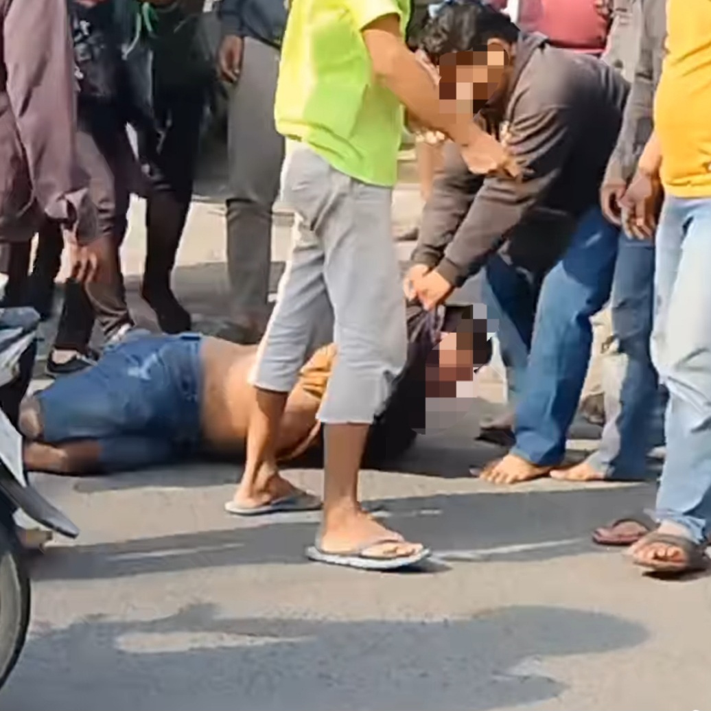 DISERET: Tersangka saat dihajar massa di Jalan Raya Lontar, Surabaya. Ia mencuri sepeda motor di lokasi.(IST/RADAR SURABAYA)