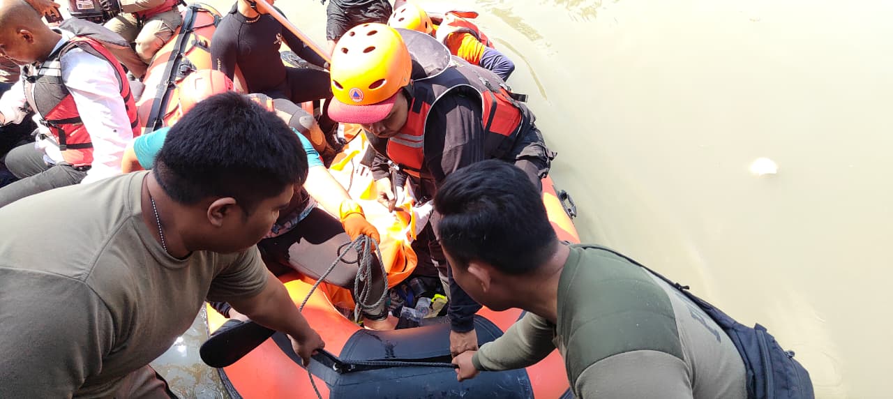 EVAKUASI: Petugas saat mengevakuasi jenazah korban lansia yang tercebur di sungai Jalan Joyoboyo, Surabaya. (MAHRUS/RADAR SURABAYA)