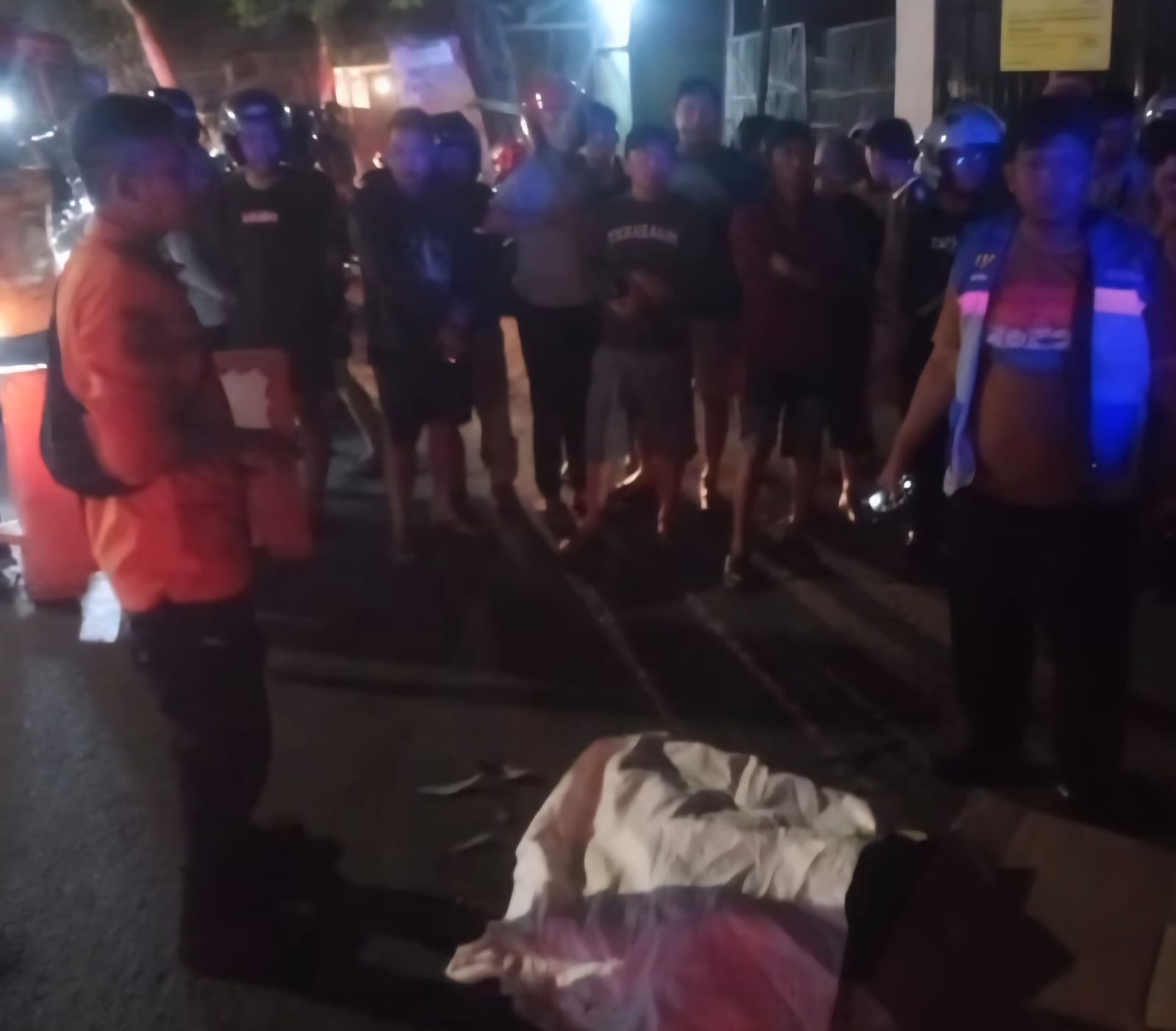 EVAKUASI: Petugas saat mengevakuasi jasad mahasiswi yang meninggal dunia terlindas truk di Jalan Mastrip, Surabaya. (IST/RADAR SURABAYA)