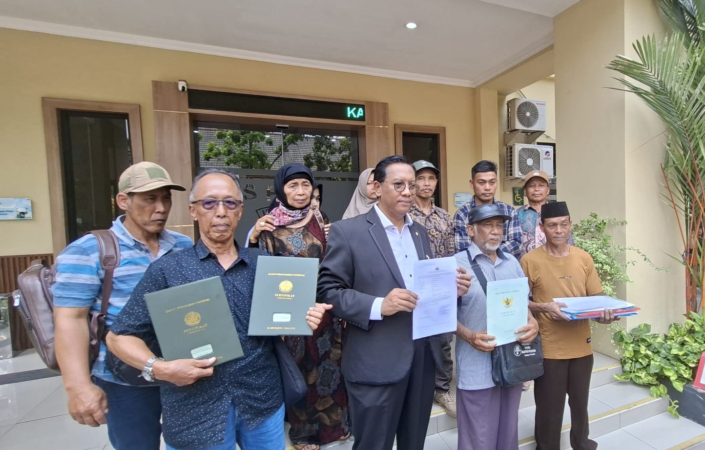 DATANG: Puluhan warga melaporkan adanya dugaan mafia tanah di Desa Balesari, Malang, saat berada di Polda Jatim. (MAHRUS/RADAR SURABAYA)
