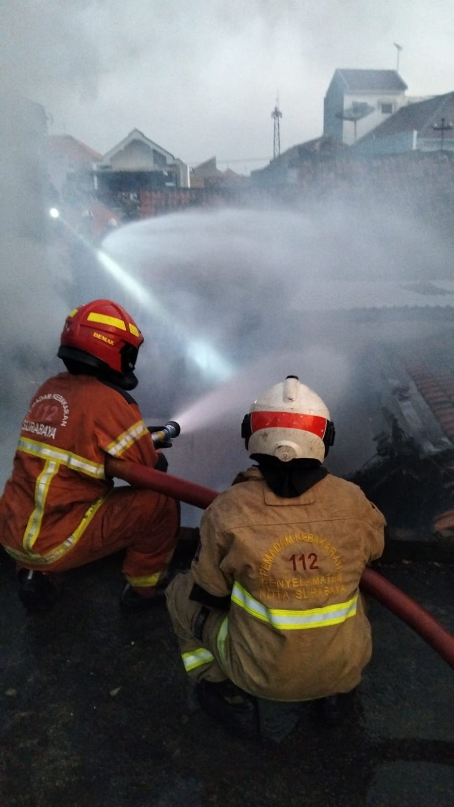 UPAYA: Petugas DPKP Surabaya saat melakukan pemadaman di Jalan Nyamplungan, Surabaya. Enam rumah terbakar dalam kejadian ini. (IST/RADAR SURABAYA)