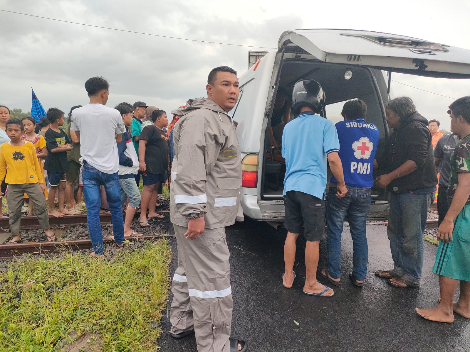 EVAKUASI: Petugas gabungan saat mengevakuasi jasad MJ yang tertabrak KA di Jalan Raya Desa Jati Alun-alun, Prambon, Sidoarjo. (IST/RADAR SURABAYA)