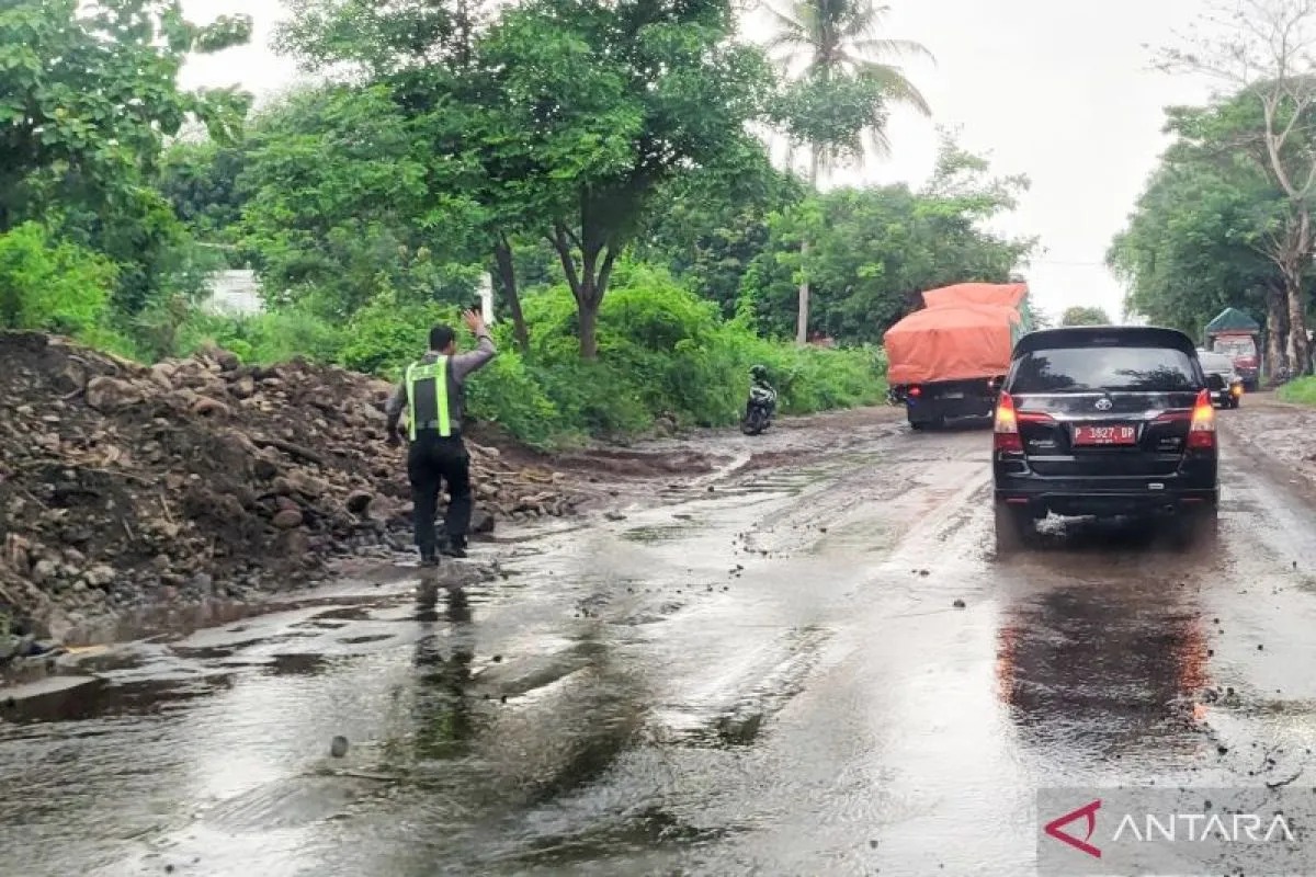 Anggota Satlantas Polres Situbondo disiagakan di lokasi banjir material batu di jalur pantura Dusun Kembangsambi, Desa Pasir Putih, Kecamatan Bungatan. (ANTARA)