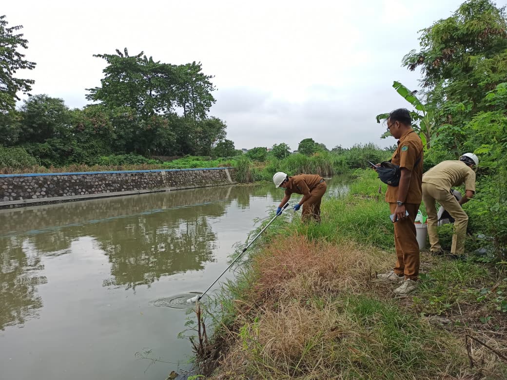 BUTUH SEMPEL: Petugas DLHK melakukan pengecekan sungai. (DIKY SANSIRI/RADAR SURABAYA)