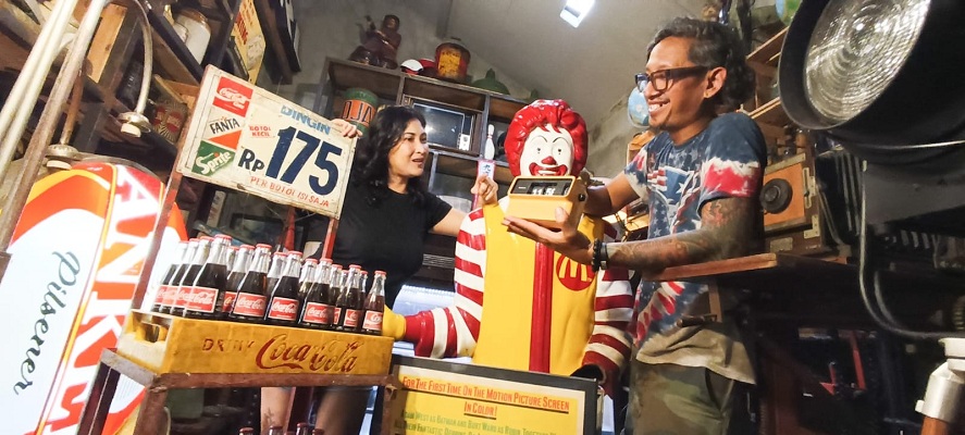 BERBURU BARANG RETRO: Johonas (kanan) melayani pelanggan yang mencari barang-barang retro di Wasik Galeri miliknya, di kawasan Dukuh Kupang, Surabaya, Senin (9/2).