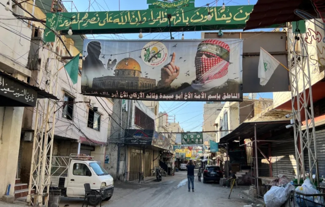 Spanduk bergambar Abu Obeida, mantan juru bicara sayap bersenjata Hamas yang tewas di Gaza tahun lalu, terlihat di kamp pengungsi Palestina Ein el-Hilweh, dekat Sidon, Lebanon selatan. 