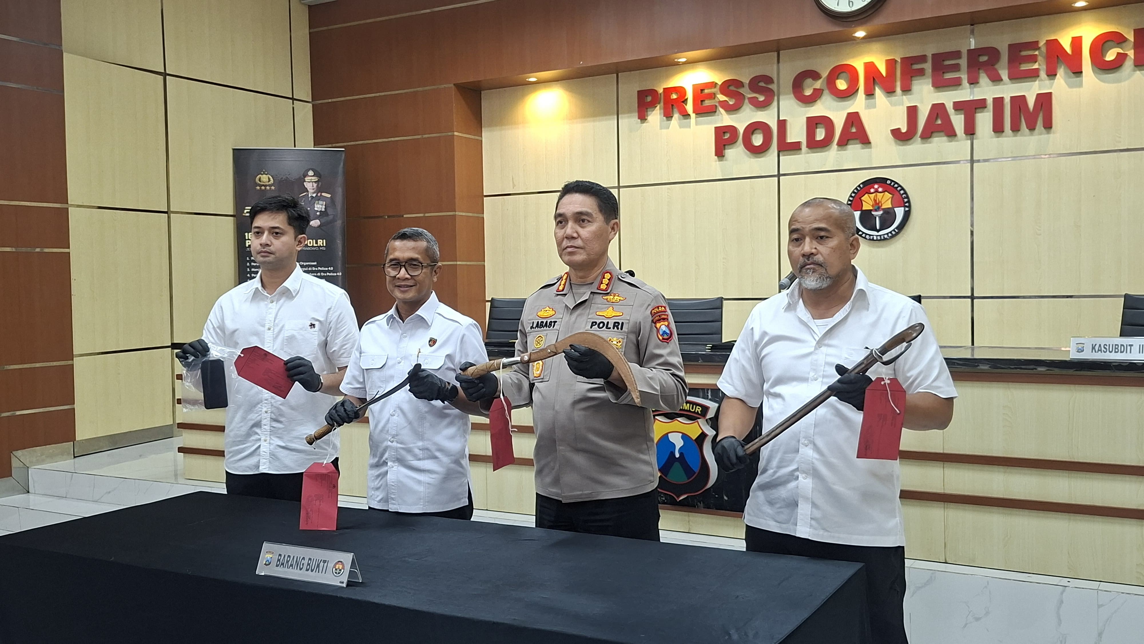DISITA: Kabid Humas Polda Jatim Kombes Pol Jules Abraham Abast (dua dari kanan) dan Kasubdit III Jatanras AKBP Arbaridi Jumhur (kanan) menunjukkan sajam yang digunakan tersangka mengancam korbannya.