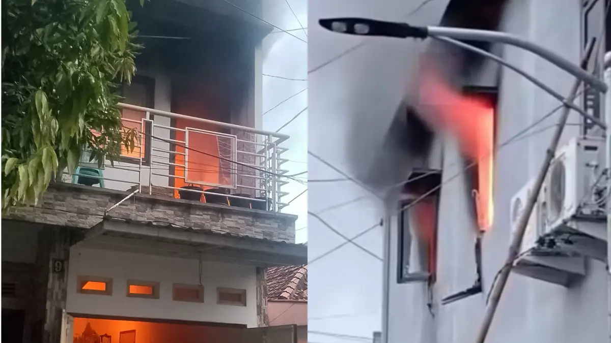 MEMBARA: Api terlihat membara membakar kamar lantai dua rumah Amajah di Jalan Gubeng Jaya II, Surabaya, Kamis (2/4). (ISTIMEWA)