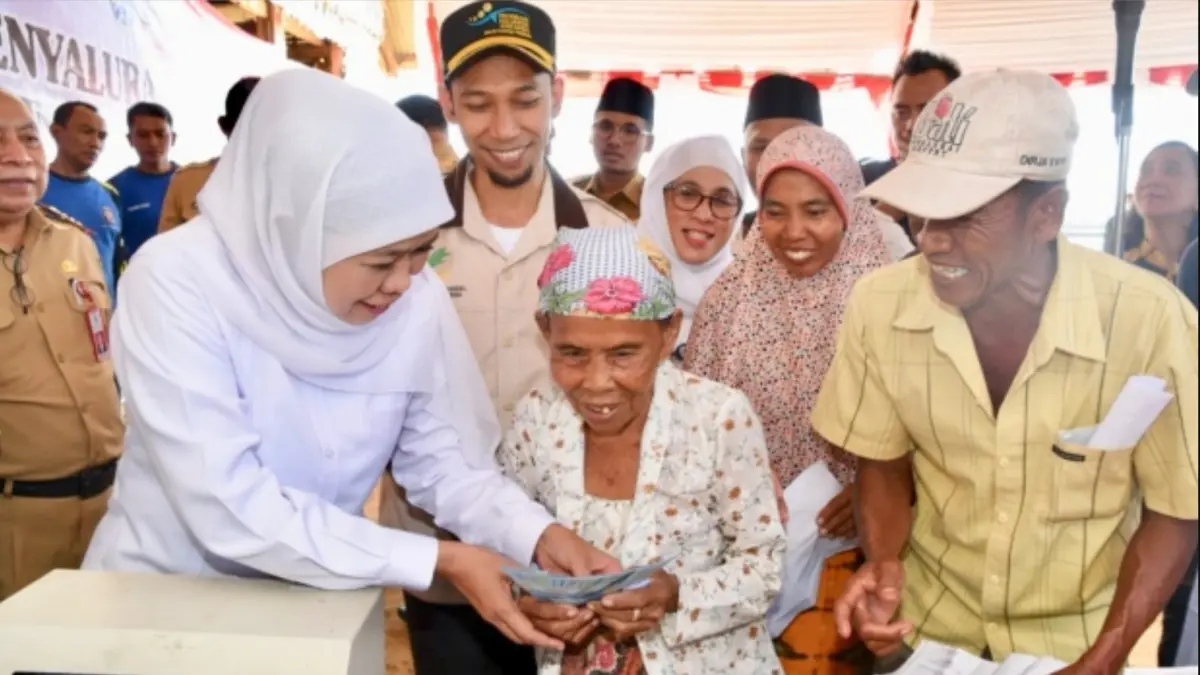 Gubernur Jawa Timur Khofifah Indar Parawansa saat menyalurkan bansos PKH. (DOK. HUMAS PEMPROV JATIM)