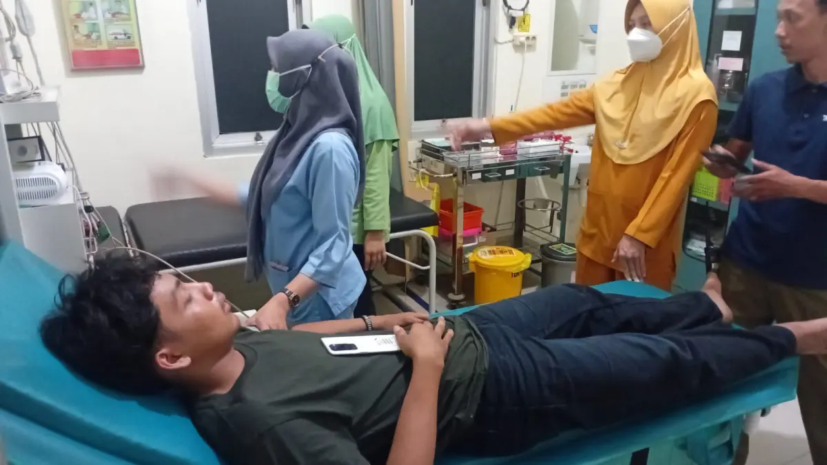 DIRAWAT: Salah satu korban mendapat perawatan medis usai menjadi korban pengeroyokan oknum pesilat di Kendangsari Industri, Surabaya. (IST/RADAR SURABAYA)