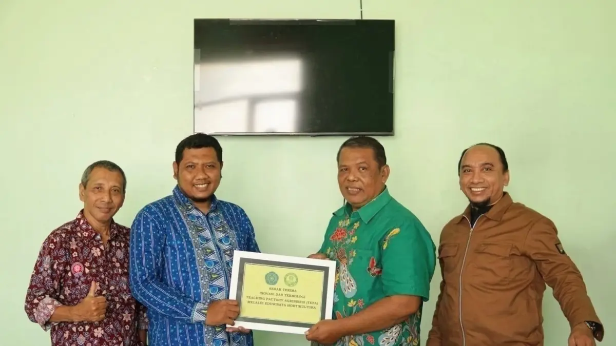 KOLABORASI: Ketua Tim Heru Baskoro (dua dari kanan) bersama anggota menyerahkan hasil TEFA kepada Kepala SMK Muhammadiyah 5 Panceng Gresik.(IST/RADAR SURABAYA)