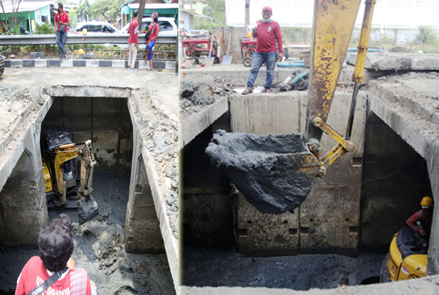 PEMBERSIHAN SALURAN: Satgas dari Dinas PU Kota Surabaya dengan menggunakan alat berat berukuran besar dan kecil membersihkan endapan lumpur di dalam gorong-gorong Jalan Babat Jerawat, Selasa (7/9). Pembersihan dilakukan untuk memperlancar saluran air. (AN