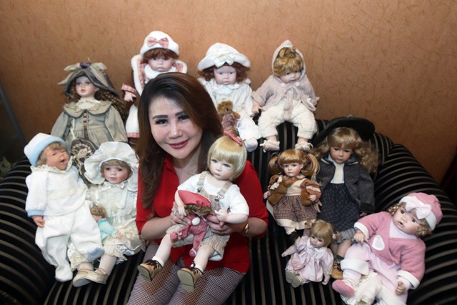 DARI YANG MURAH SAMPAI MAHAL: Natalia Tanudjaja menunjukkan koleksi bonekanya yang sebagian besar berbahan porselen yang dia dapatkan dari beberapa negara di rumahnya kawasan Surabaya Barat, Senin (10/1). (ANDY SATRIA/RADAR SURABAYA)