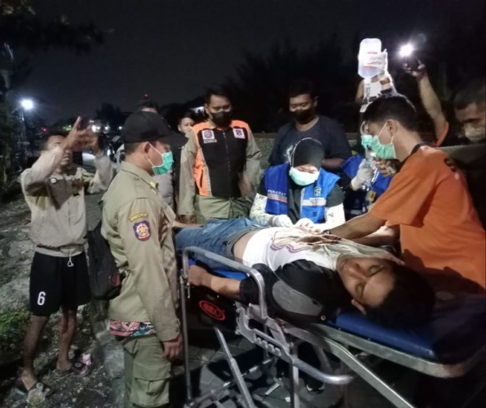 DIEVAKUASI: Petugas mengangkat korban untuk dibawa ke ambulans menuju RS Bhakti Dharma Husada, Surabaya. (IST)
